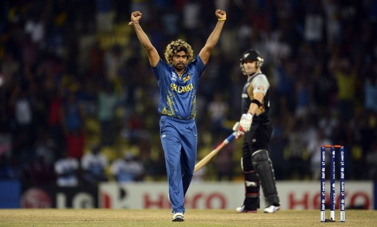 Sri Lanka''s Malinga celebrates after dismissing New Zealand''s Guptill as McCullum looks on during the super over of their Twenty20 World Cup Super 8 cricket match in Pallekele