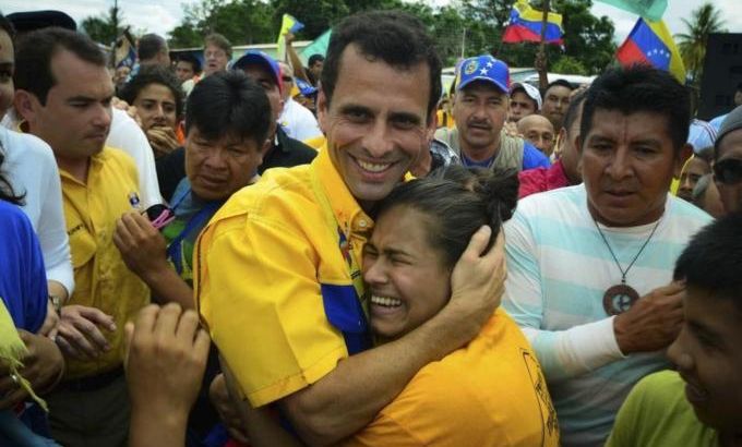 A supporter embraces opposition candidate Henrique Capriles during a rally in Santa Elena de Uairen in the southern state of Bolivar