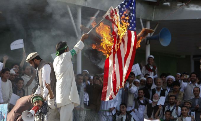 Afghan protesters set fire to a U.S. flag Kabul