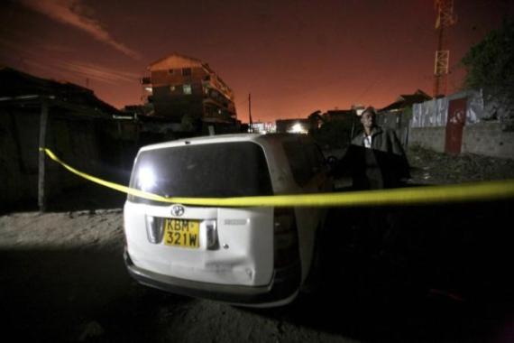 Man stands near a vehicle at the scene after two successive blasts in the residential area of Eastleigh Estate in Nairobi