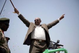 Sudanese President Omar al-Bashir waves