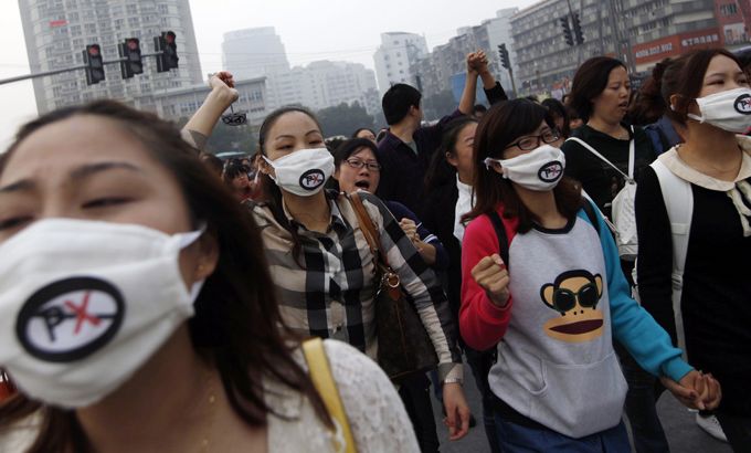 People shout slogans as they protest petrochemical plant in China