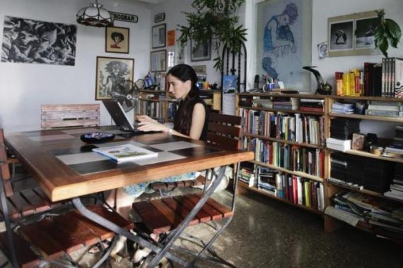 File photo of Cuban dissident blogger Yoani Sanchez working on her laptop in her home in Havana