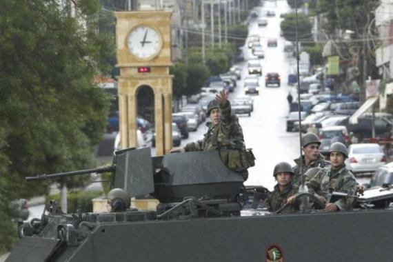 Lebanese soldiers on their military vehicle secure the scene where fighting between supporters of Lebanon''s Sunni Muslim Salafist leader Ahmad al-Assir and supporters of Lebanon''s Hezbollah took place in Sidon, southern Lebanon