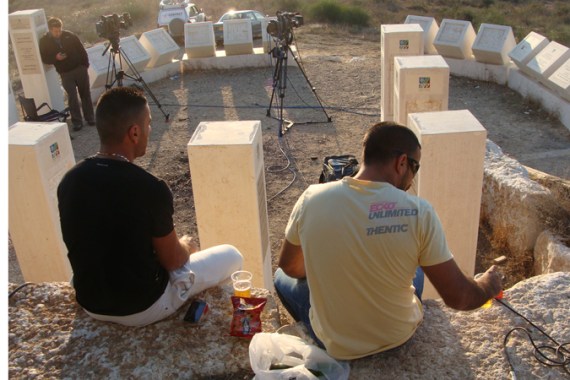 9837: At a look-out point near Sderot, two men drink beer and wait for "fireworks" in Gaza