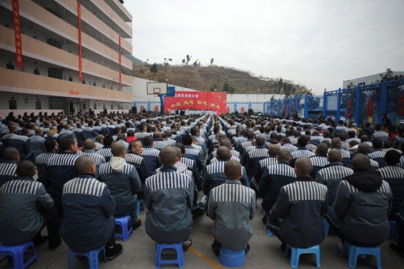 Chinese prisoners face away from camera