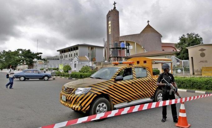 A police officer stands guard outside Holy Trinity Catholic Church in Nigeria''s capital Abuja