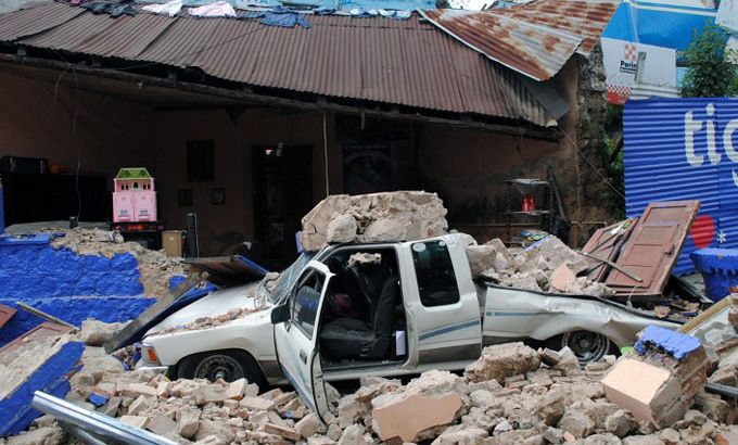a truck hit by rubble in an earthquake in Guatemala