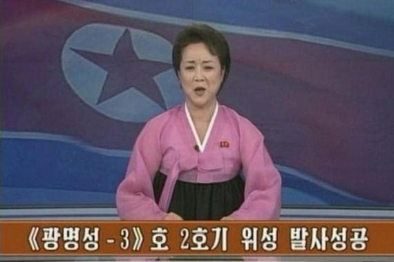 Still image of a North Korean KRT TV presenter announcing the successful launch of a long-range rocket by North Korea