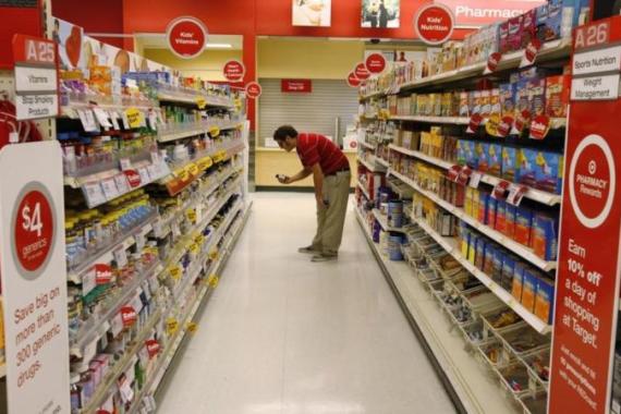 A Target store team member places an item back on the shelf at a Target store in Los Angeles