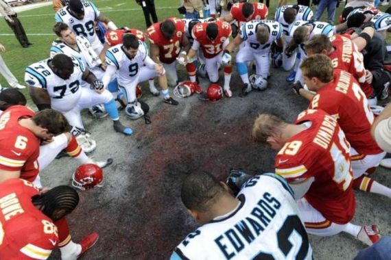 Kansas City and Carolina players form a prayer circle after a NFL football game in Kansas City, Missouri
