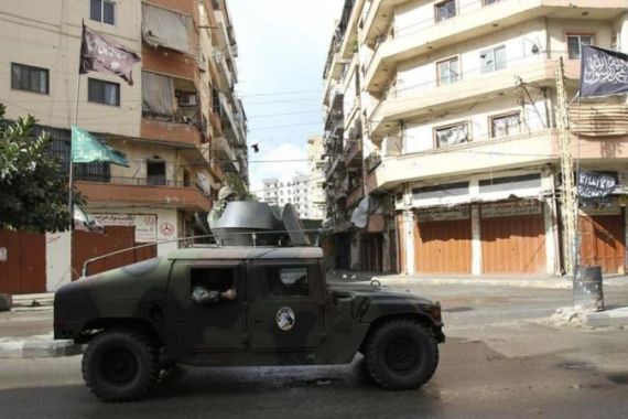 Lebanese army soldiers patrol in their vehicle in the Sunni Muslim-dominant neighbourhood of Bab al-Tebbaneh in Tripoli, northern Lebanon, during clashes between Sunni Muslims and Alawites