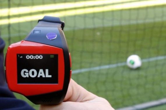 A FIFA official holds a wrist watch used as part of the Hawk-Eye goal-line technology in Toyota