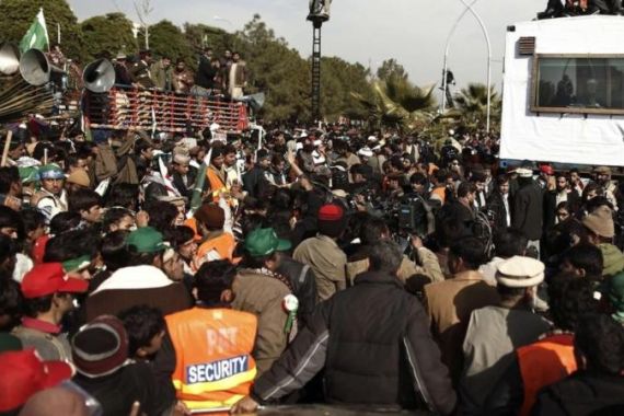Supporters of Sufi cleric and leader of Minhaj-ul-Quran Qadri gather around as he addresses them on the second day of protests in Islamabad