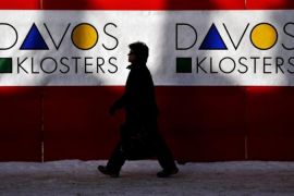 A women walks past logo of Davos/Kloster