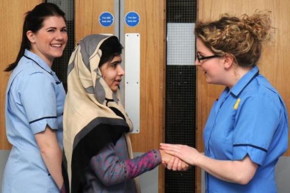 Pakistani schoolgirl Malala Yousufzai smiles with nurses as she is discharged from The Queen Elizabeth Hospital in Birmingham in this handout photograph