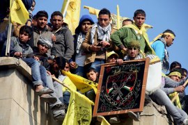 Young men in Gaza City hold the yellow flags of Fatah at a mass celebration of the faction''s 48th anniversary [Mustafa Ashqar/Al Jazeera]