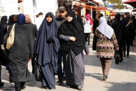Tunisian veiled women walk in Habib Bour