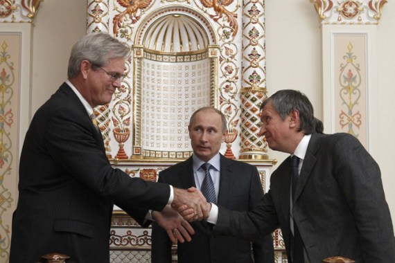 Rosneft Chief Executive Igor Sechin (R), President of ExxonMobil Exploration Company Stephen Greenlee (L) and Russian President Vladimir Putin