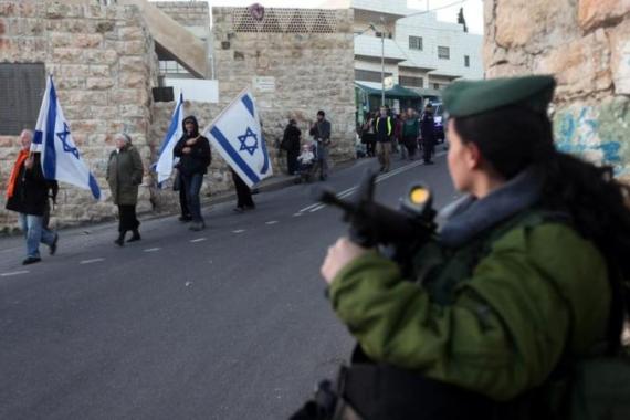 Israeli settlers marching in Hebron to return to evacuated buildings