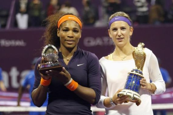 Azarenka of Belarus and Williams of U.S. hold their trophies after their Qatar Open tennis tournament final match in Doha