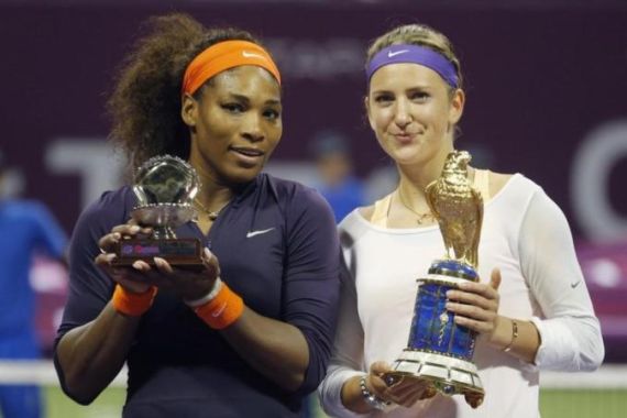 Azarenka of Belarus and Williams of the U.S. hold their trophies after their Qatar Open tennis tournament final match in Doha
