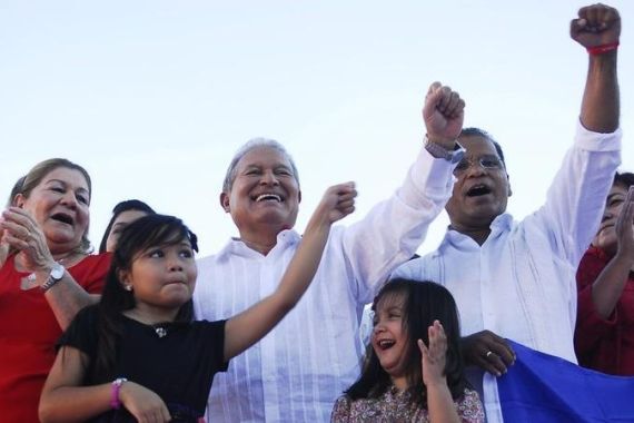 Salvador Sanchez Ceren gestures next to his grandchildren at the end of the 29th national convention of the FMLN party in San Salvador