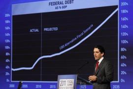 Michael Peterson of the Peter G. Peterson Foundation stands beside a chart showing the projected federal debt as a percentage of GDP at the 2011 Fiscal Summit on Solutions for America''s future in Washington