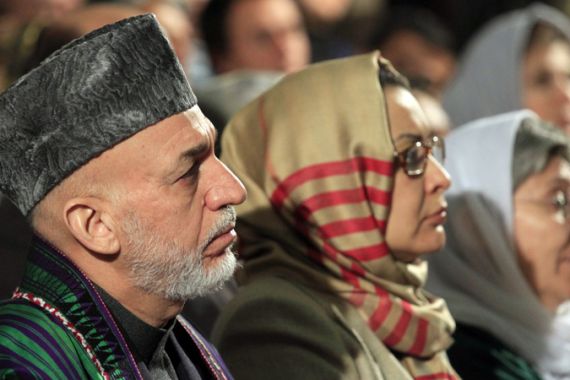 Afghan President Hamid Karzai (L) attends an event commemorating International Women''s Day