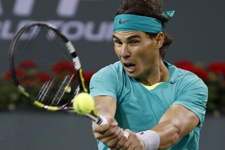 Rafael Nadal of Spain hits a return against Ryan Harrison of the U.S. during their match at the BNP Paribas Open ATP tennis tournament in Indian Wells