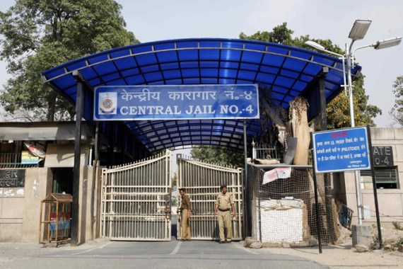 Police stand guard at one of the gates of the Tihar Jail in New Delhi