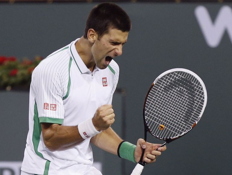 Djokovic of Serbia celebrates breaking the serve of Fognini of Italy during the third set of their match at the BNP Paribas Open ATP tennis tournament in Indian Wells, California