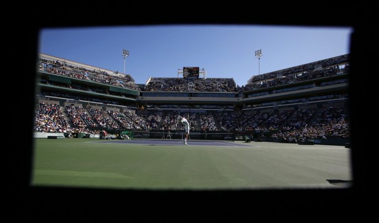 Djokovic of Serbia serves to Dimitrov of Bulgaria at the BNP Paribas Open ATP tennis tournament in Indian Wells, California
