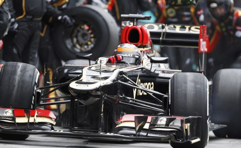Lotus Formula One driver Kimi Raikkonen of Finland drives in the pit lane during the Australian F1 Grand Prix at the Albert Park circuit in Melbourne