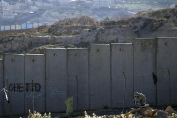Palestinian at wall near Hizme and Pizgat Zeev