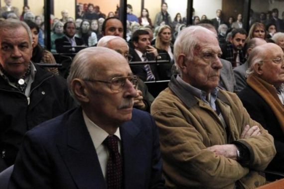 Jorge Videla and Reynaldo Bignone listen to the verdict during their trial in a courthouse in Buenos Aires