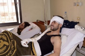 A man injured by chemical weapons smiles during the visit of Syrian government officials at a hospital in Aleppo