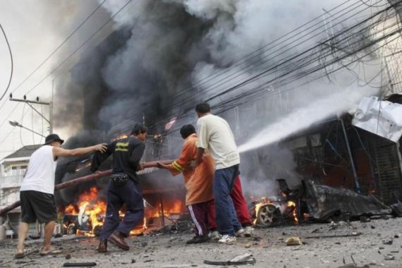 Security forces and firefighters work at the scene of a car bomb attack in southern Thailand''s Narathiwat province