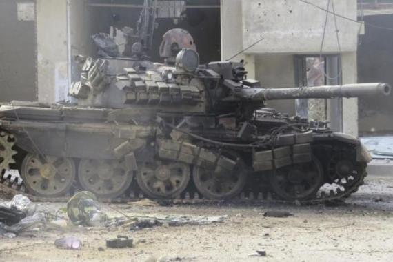 A tank belonging to forces loyal to Syria''s President Bashar al-Assad, is damaged by Free Syrian Army fighters after they seized a government checkpoint in Deraa