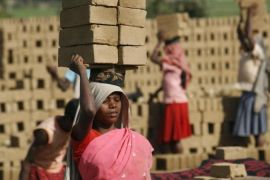 Women labourers work in a brick factory on International Women''s Day in Jirania village
