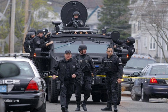 SWAT teams enter a suburban neighborhood to search an apartment