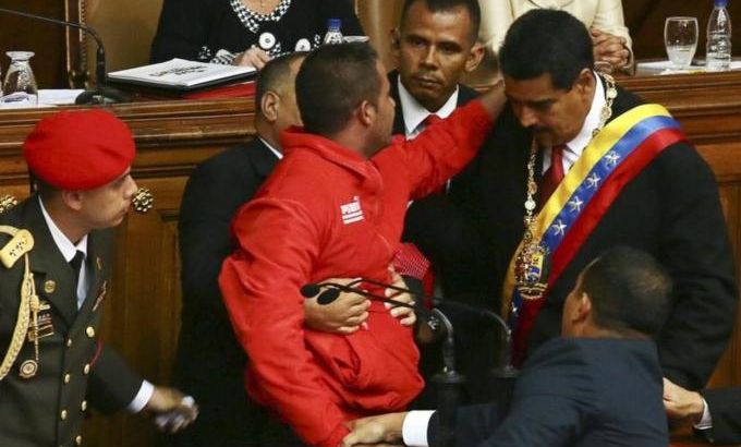 An unidentified man attempts to embraces to Venezuela''s President Maduro during his speech after Maduro was sworn into office, in Caracas
