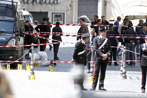 Carabinieri police stand as they patrol around the area where gunshots were fired, in front of Chigi Palace, in Rome