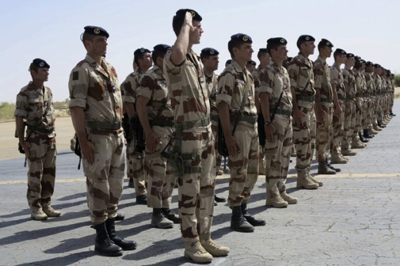 French troops stand at attention during a handover ceremony of the Timbuktu mission from France to Burkina Faso at Timbuktu airport