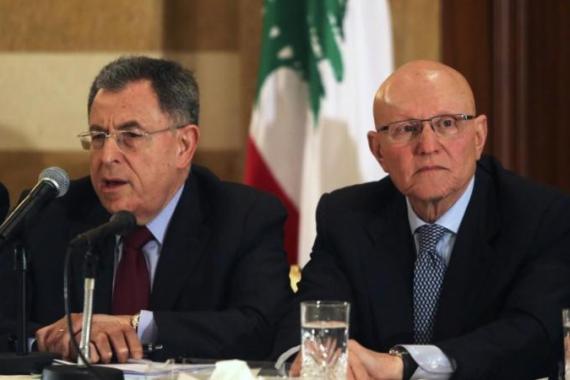 Lebanese former prime minister Fouad Siniora speaks during a meeting for pro-Western March 14 political coalition as former minister Tammam Salam looks on, in Beirut