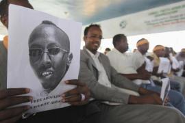 A Somali journalist holds a poster bearing the image of Ibrahim as they demand for his release in capital Mogadishu