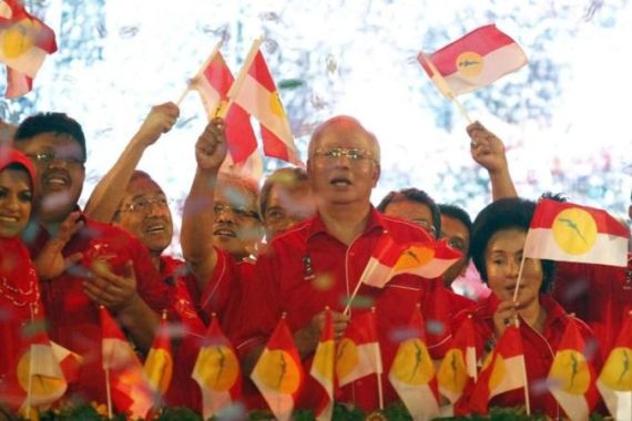 File photo of Malaysia''s Prime Minister Razak and party leaders of country''s ruling United Malays National Organization waving UMNO''s flags during 66th anniversary celebrations in Kuala Lumpur