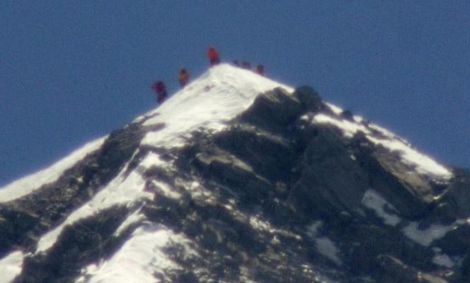 A team of climbers including 80-year-old Japanese mountaineer Yuichiro Miura stand on the summit of Mount Everest