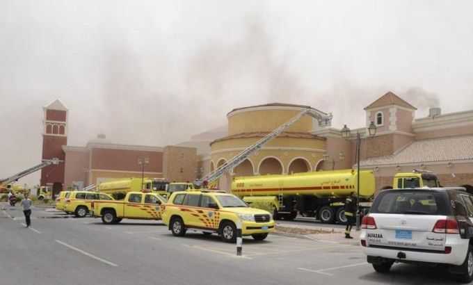 Firefighters attempt to extinguish a fire at the Villagio Mall in Doha
