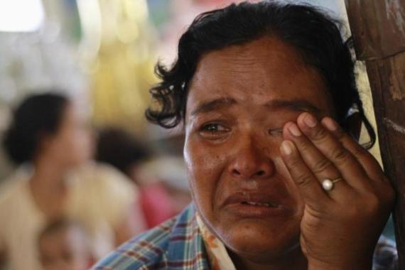 Muslim woman cries in monastery used to shelter internally displaced people after riot between Muslims and Buddhists in Lashio township